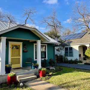 Balcones Roofing & Remodeling24-Gauge 1" Standing Seam Metal Roof in Sheffield Ash Gray beside F-Wave Revia American Blends in Birchwood - Austin, Texas