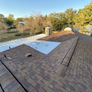 Balcones Roofing & RemodelingCertainteed LandMark Pro in Burnt Sienna & 24-Gauge 1" Standing-Seam Metal Roofing in Sheffield Galvalume - Austin, Texas
