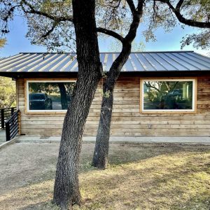 Balcones Roofing & Remodeling24-Gauge Standing Seam Metal Roof in Berridge Pre-Weathered Galvalume & Matte Black Half-Round Gutters _ Spicewood, Texas