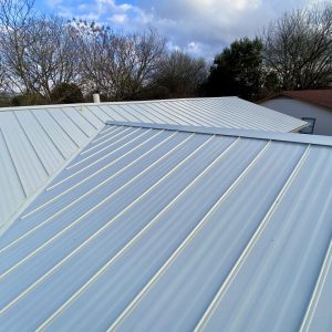 Balcones Roofing & Remodeling24-Gauge 1" Stenading- Seam Metal Roof in Sheffield Sandstone - Austin, Texas